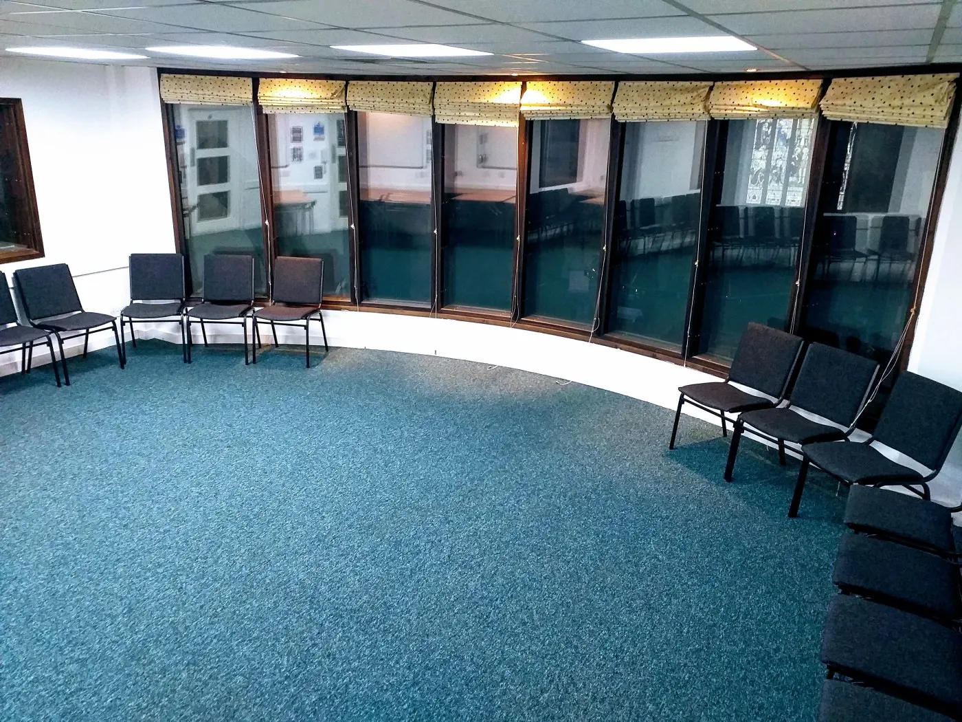 The carpeted Adelaide Room with tables and chairs